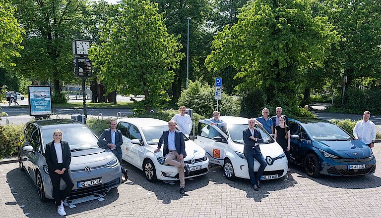 Personen posieren vor neuen E-Ladepunkten für E-Carsharing-Fahrzeuge in Oldenburg